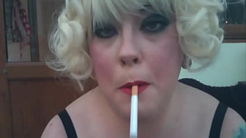 Chubby Domme In Wig Smokes A Cig