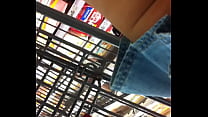 At store in blue jean shorts skirt